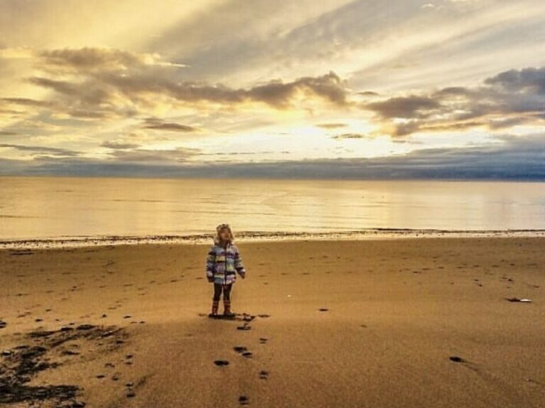 child beachcombing