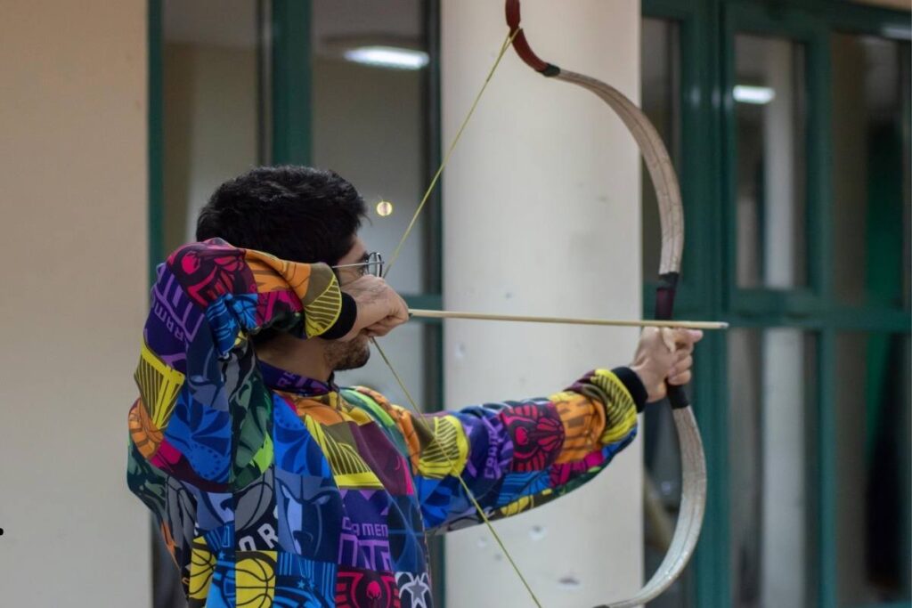 Families enjoying indoor games at the Northern Archery Simulator in Soldotna