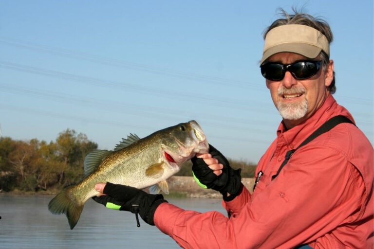 Fishing guide holding a large fish during an Alaska fishing trip